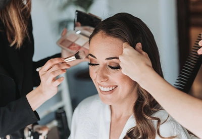 make up artist working with bride